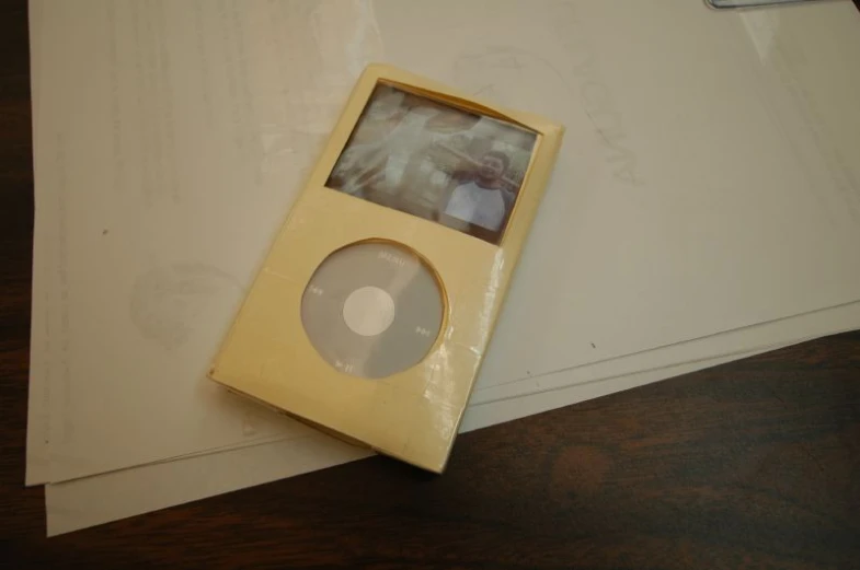 a mp3 player sitting on top of white papers