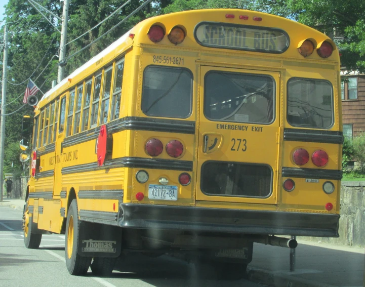 the school bus is driving down the road