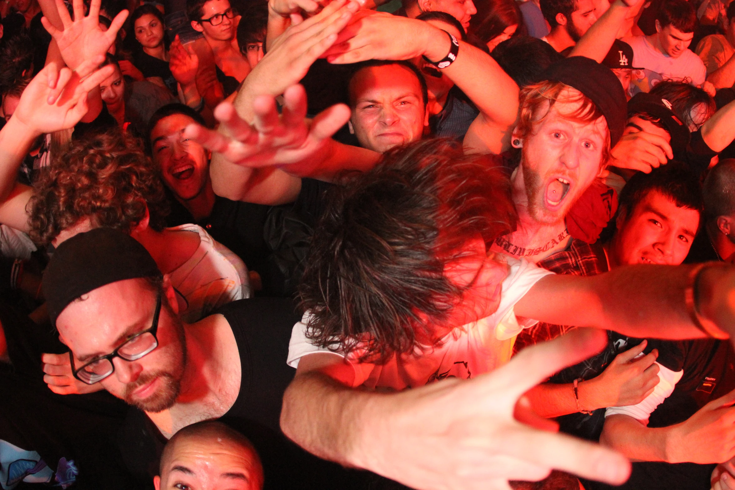 a group of people with one person raising his hands in the air