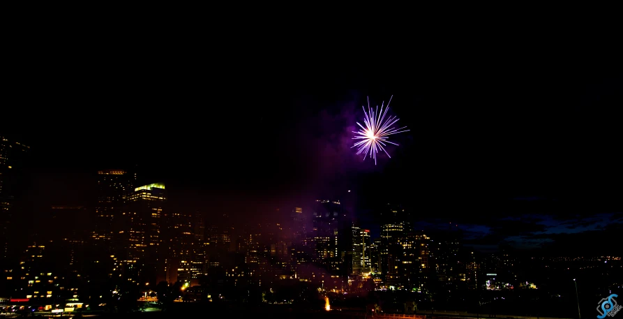 fireworks light up the sky in an empty city