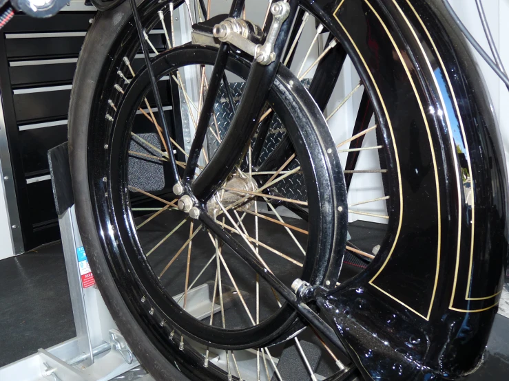 an ornate bicycle is displayed with shiny tire treads