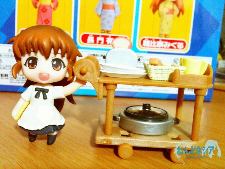 a little doll standing next to a wooden cart