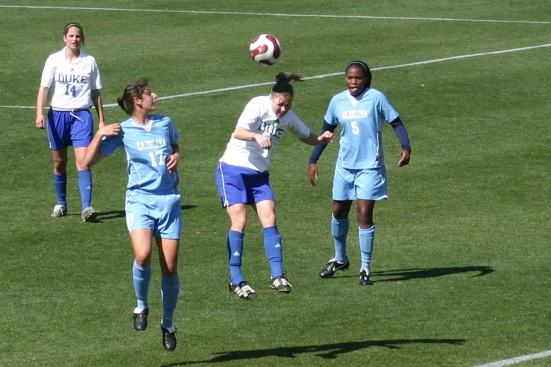 a group of s kicking around a soccer ball