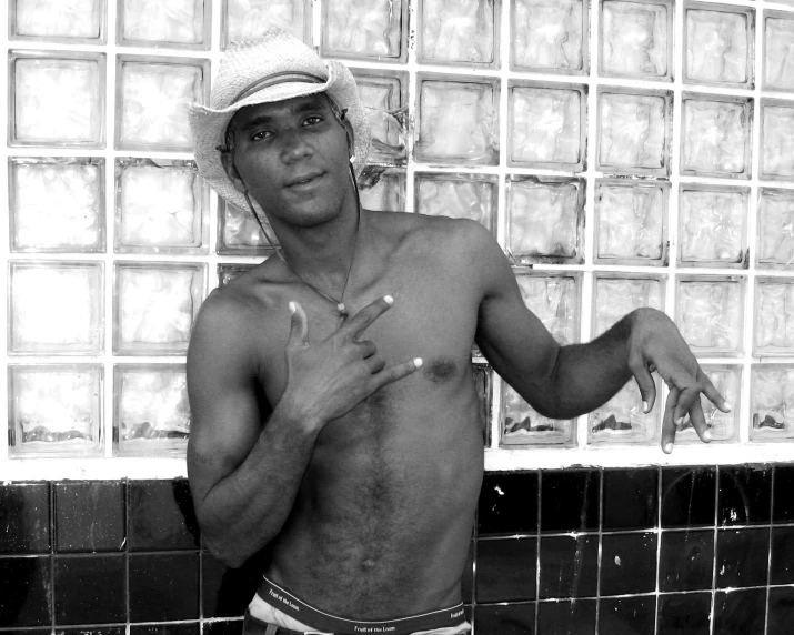 black and white po of a man leaning against a shower