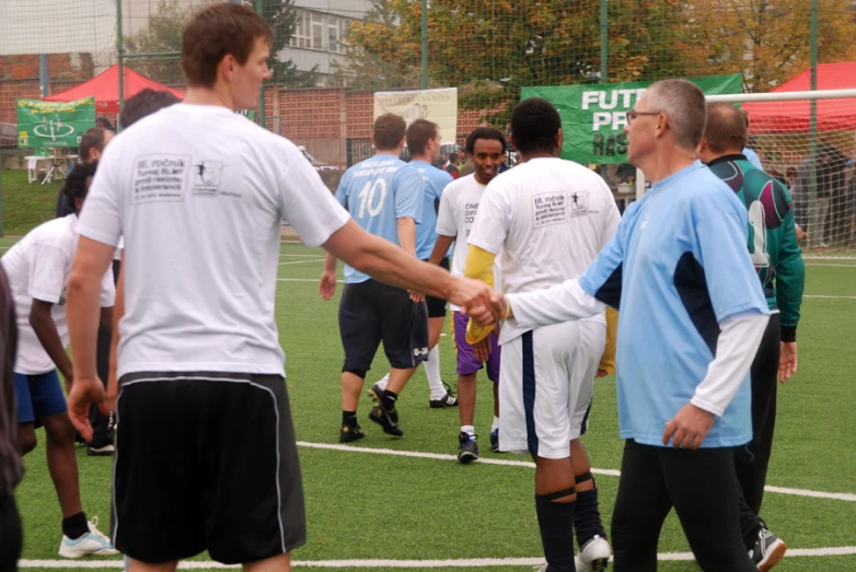 a soccer team shaking hands with each other