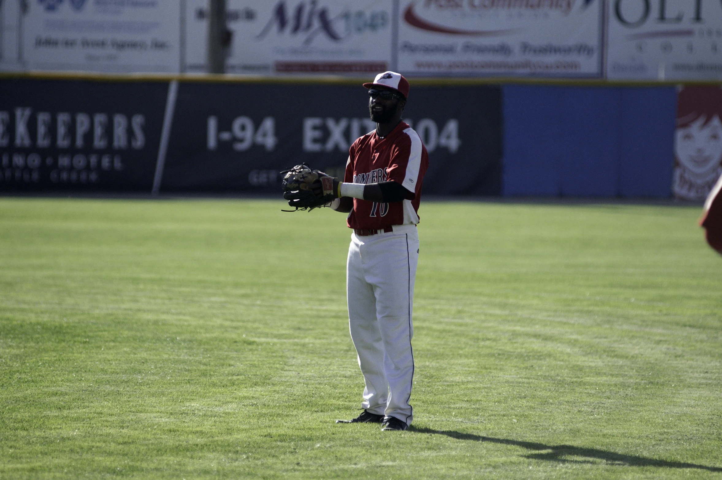 a man standing on a field holding a glove