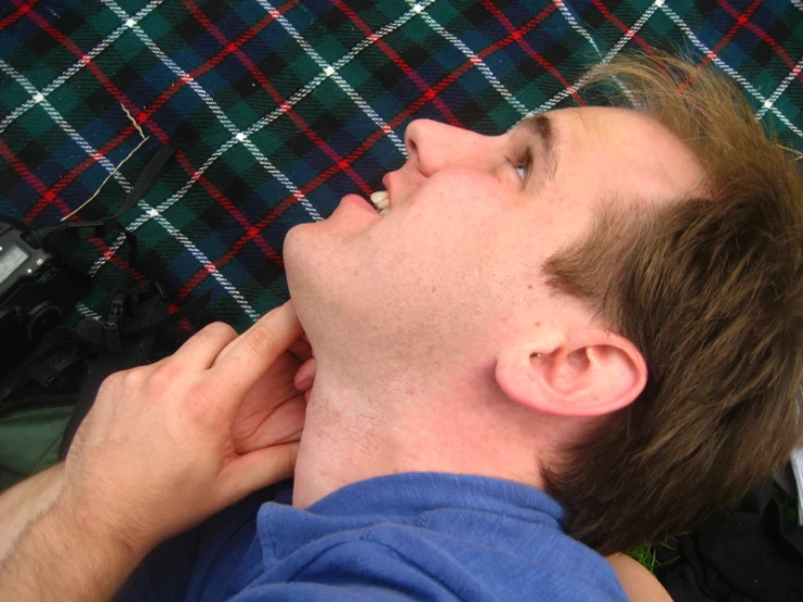 a person laying down and talking on the phone