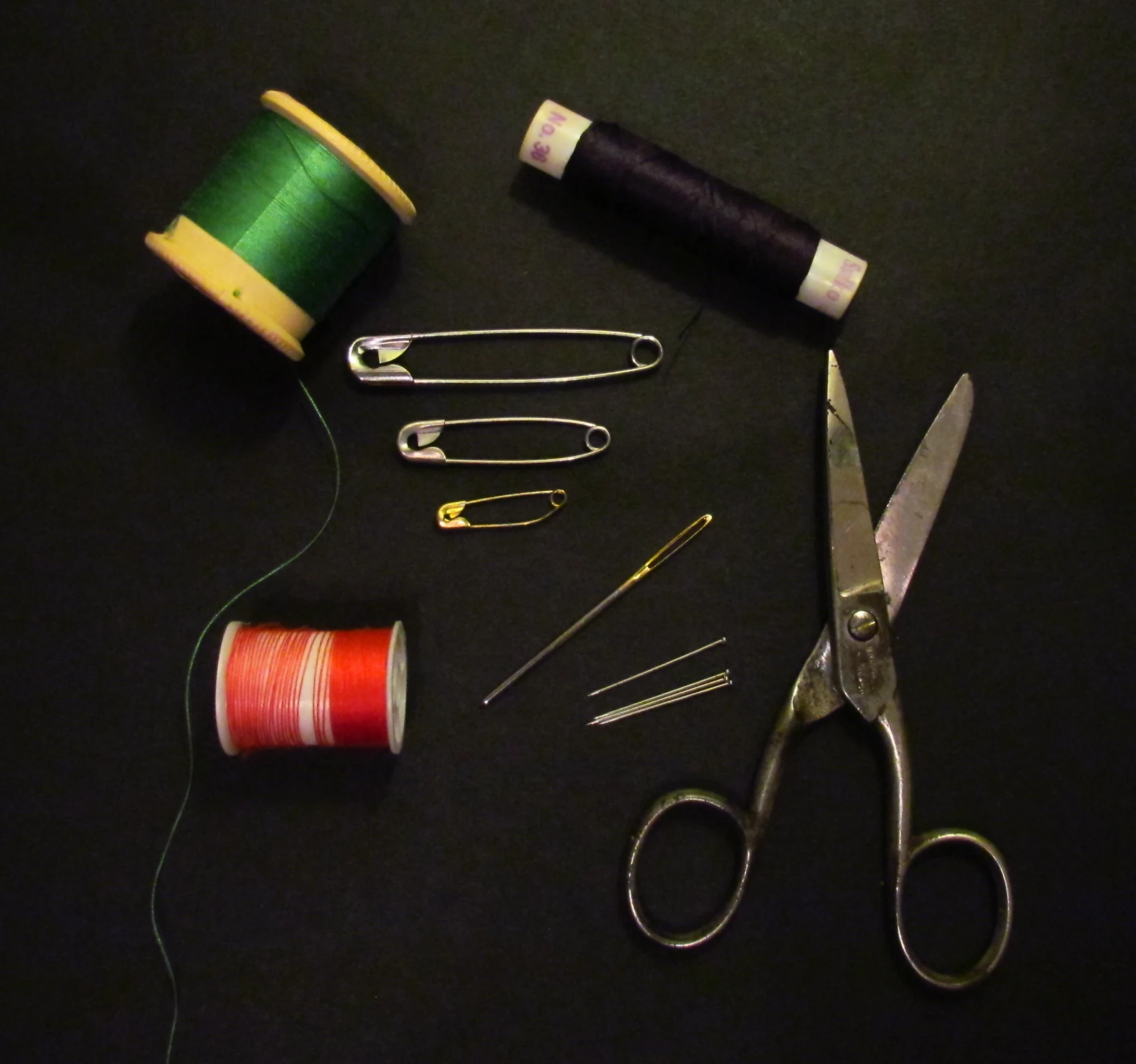 a pair of scissors and thread with the other items for sewing