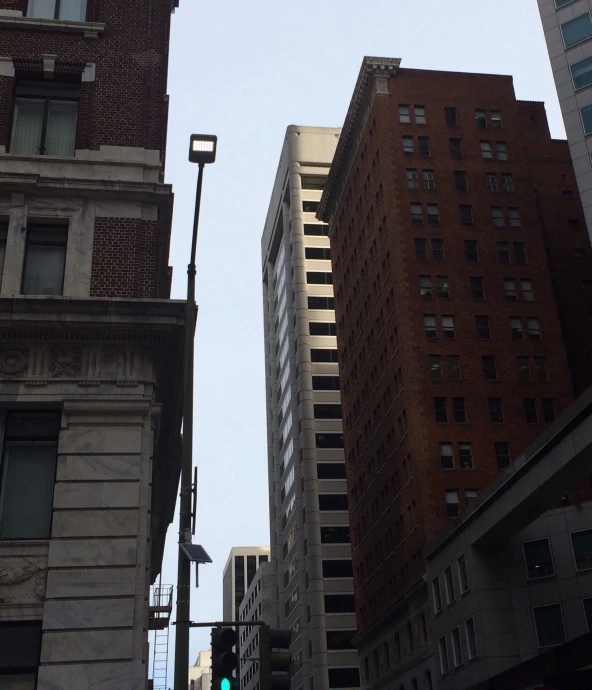 buildings are shown against a light green street sign