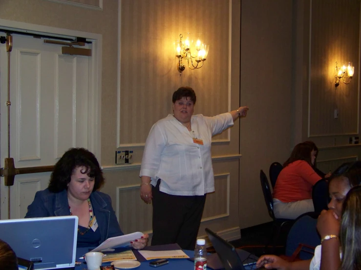 some women at a desk with laptops and notebooks