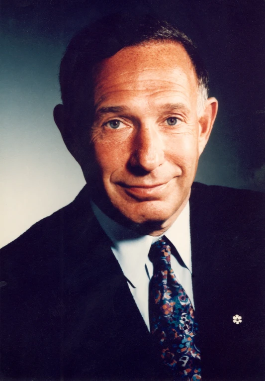 a man wearing a suit and tie posing for the camera
