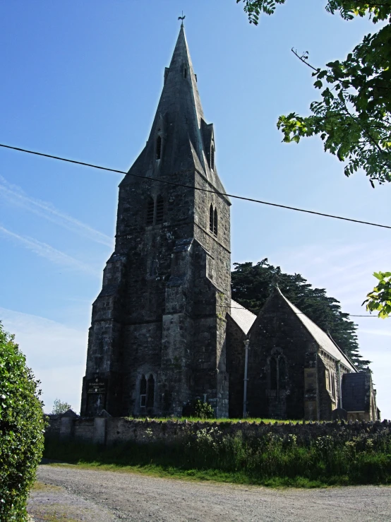 an old church next to a lush green field