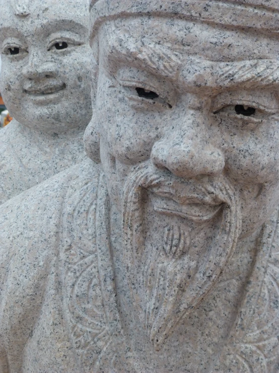 stone statues with faces are being displayed outside