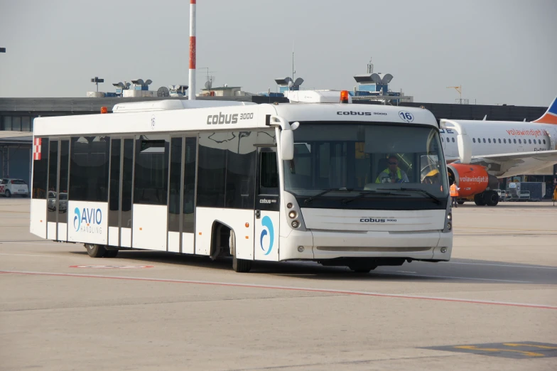 a large passenger bus sitting on top of an airport runway