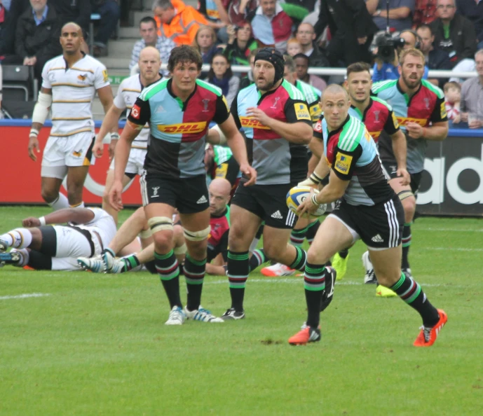 a group of rugby players compete on a field