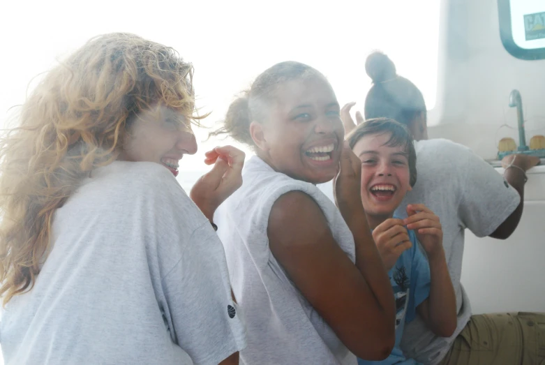 young people laugh while brushing their teeth together