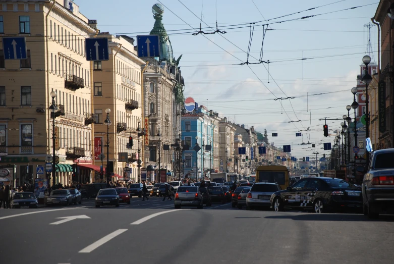 a city street filled with lots of traffic on a sunny day