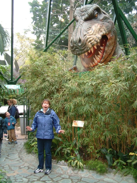 a person is standing near a large animal model