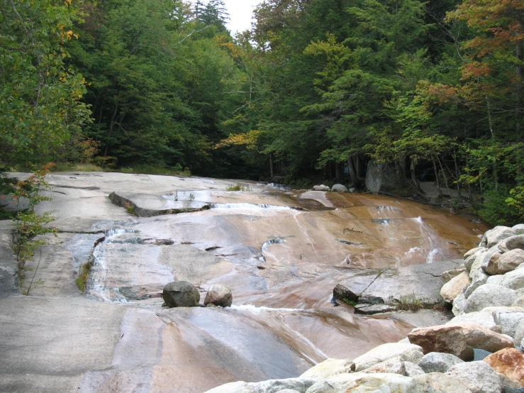 an image of a very pretty rocky river in the woods