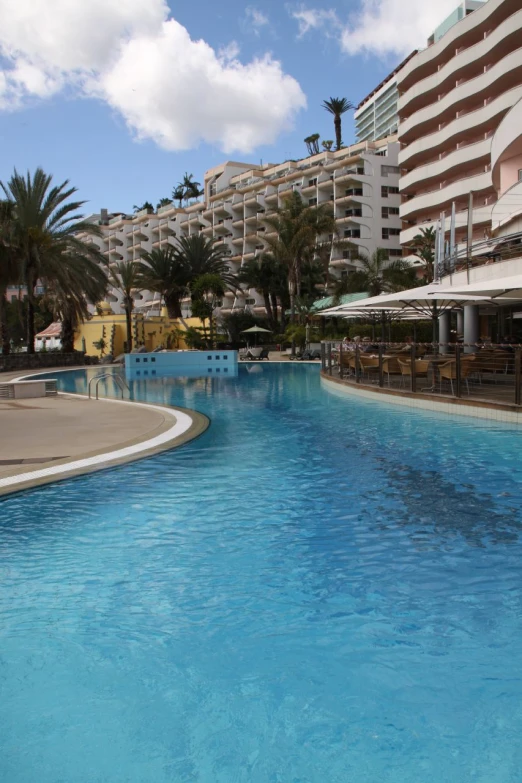 this is a large swimming pool with a lot of chairs