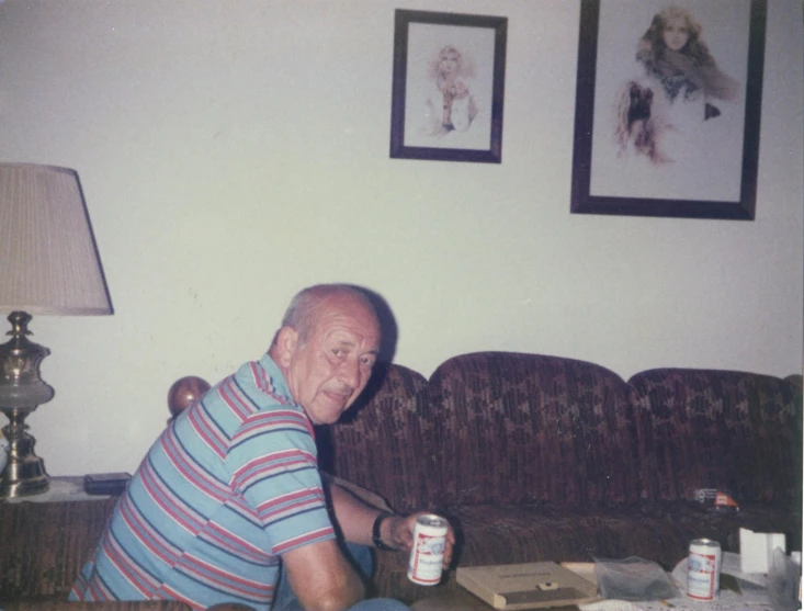 an older man sitting on top of a couch