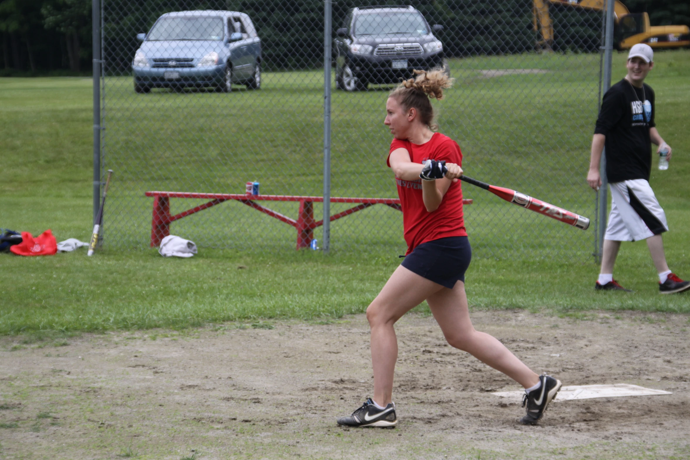 a woman with baseball bat at home base during a game