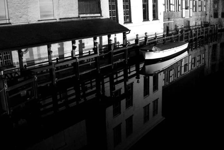 a boat sitting on the water next to a building