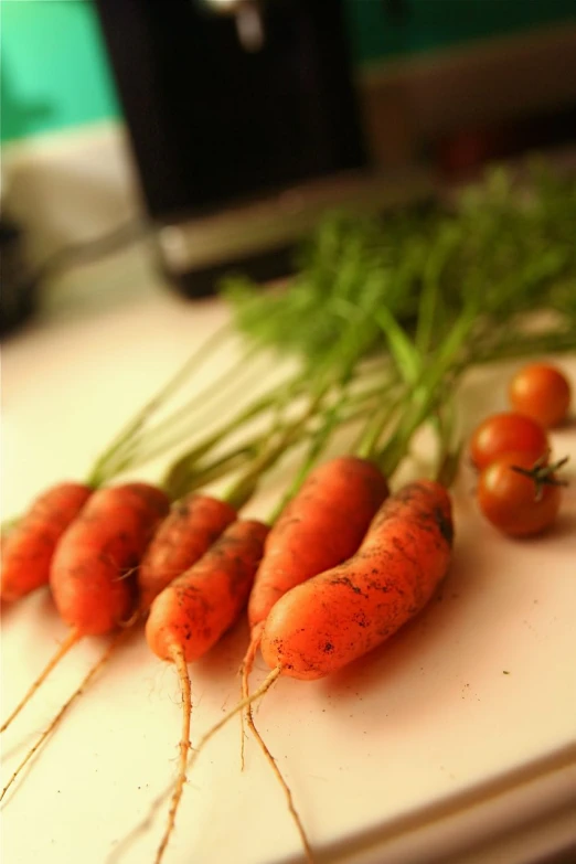 there are bunches of carrots sitting on a counter top