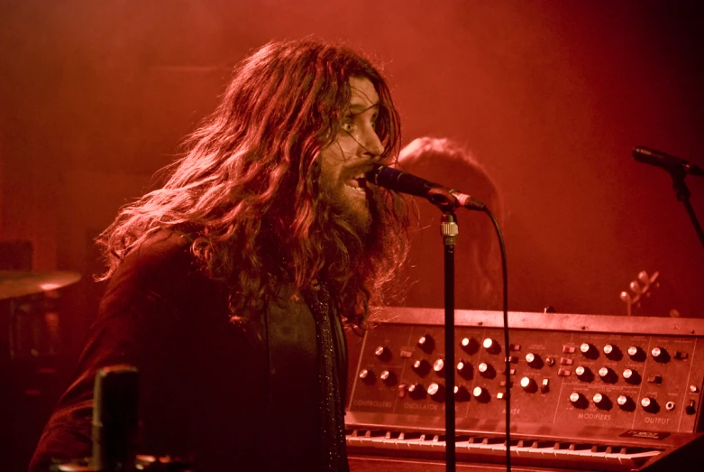 the band member in black stands on stage with his instrument