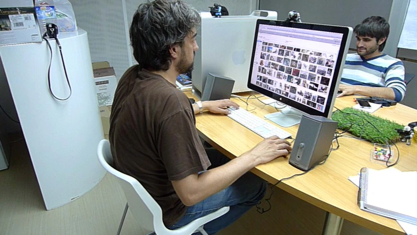 a man is sitting at his desk with a computer