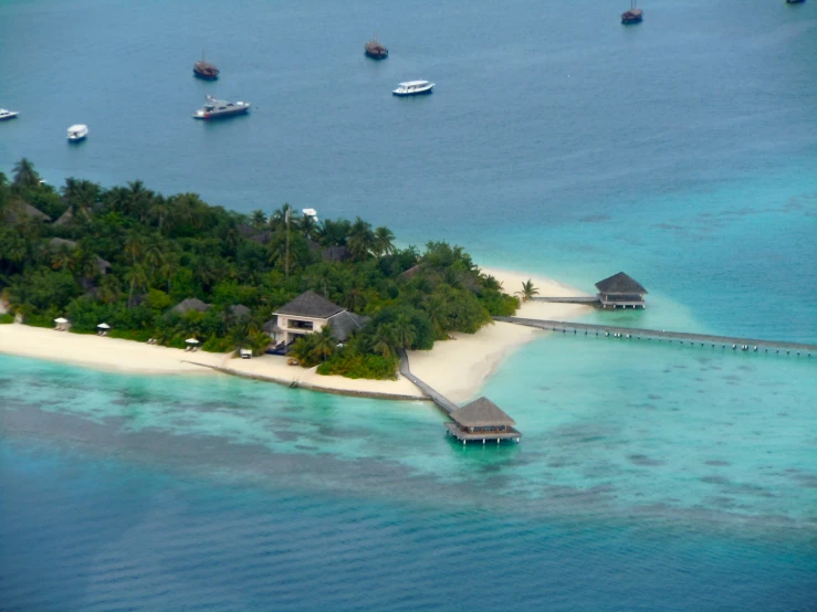 a small island with a few boats in the water