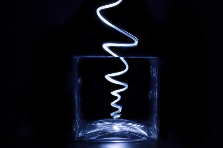 an image of a lit spiral in a glass container