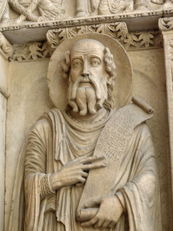 a close - up image of a stone statue with an arch above it