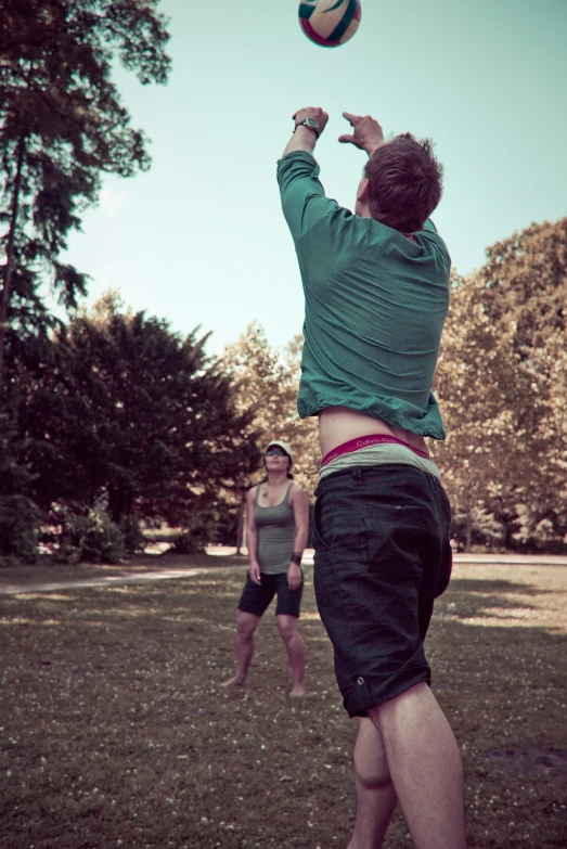 a man leaps into the air to catch a frisbee