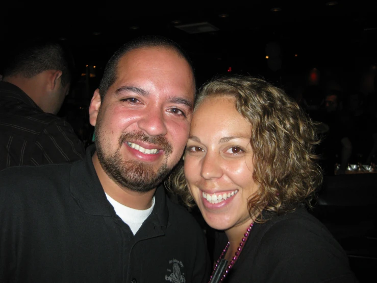 a man and woman posing for a picture together