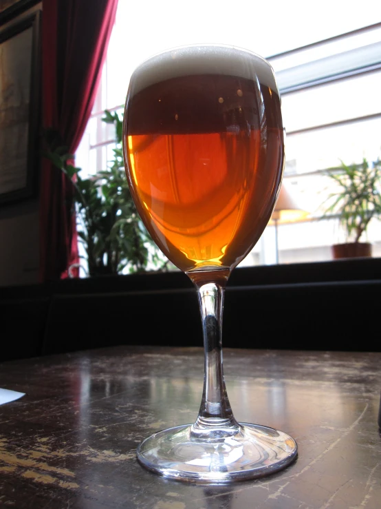 a view of a glass on the table in front of a window