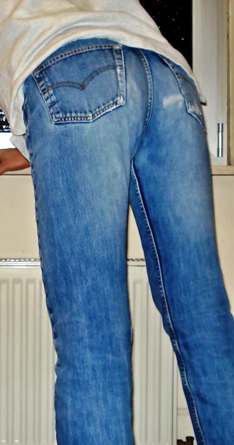 a person in jeans standing over their head