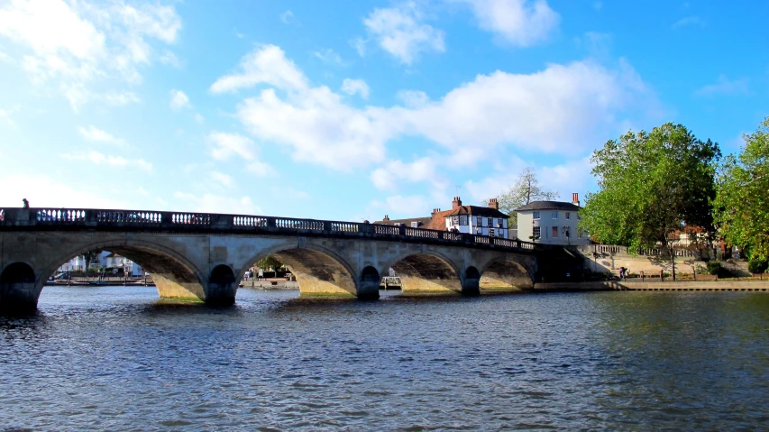 a bridge over water with old buildings around it