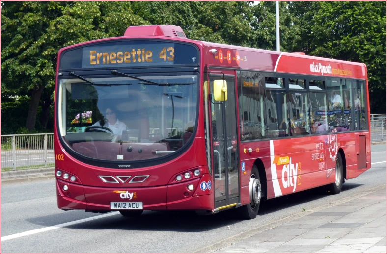 a red bus parked on the side of the road