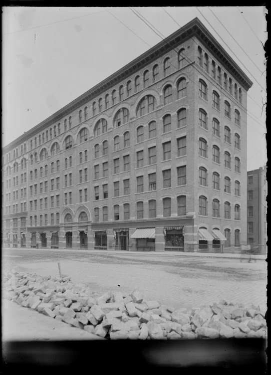 an old po shows a large building near rocks