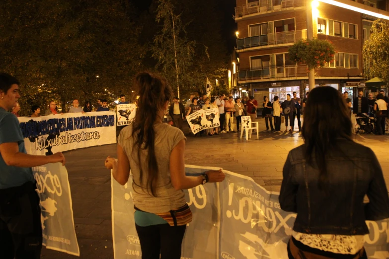 a man and woman are standing near a group of protesting