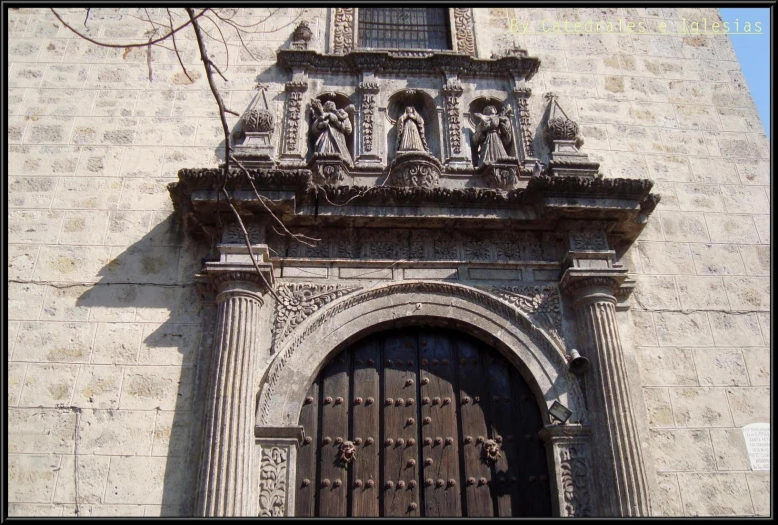 an old church door in front of a brick wall