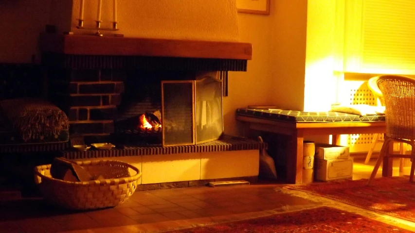 a fire place and a chair with pillows on it