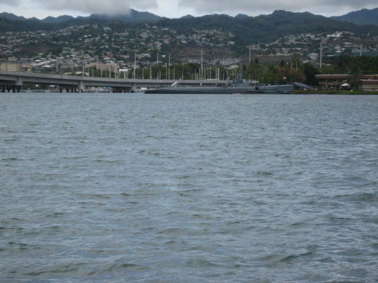 several boats on a river next to a city