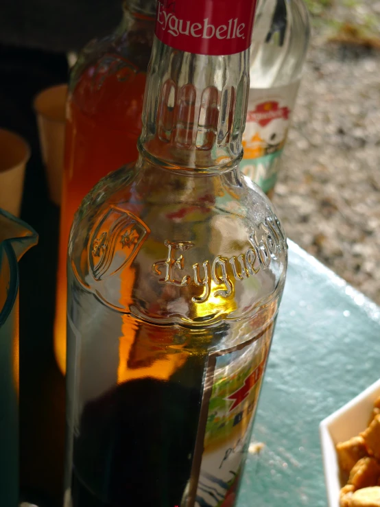 this is a glass bottle of liquor and some onion rings