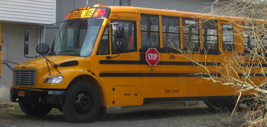 a yellow bus is parked outside a building