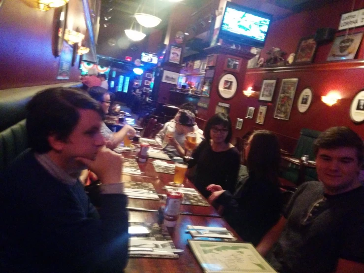 several people sitting at a bar together