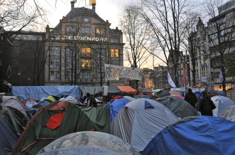 a large crowd of tents standing around an old building
