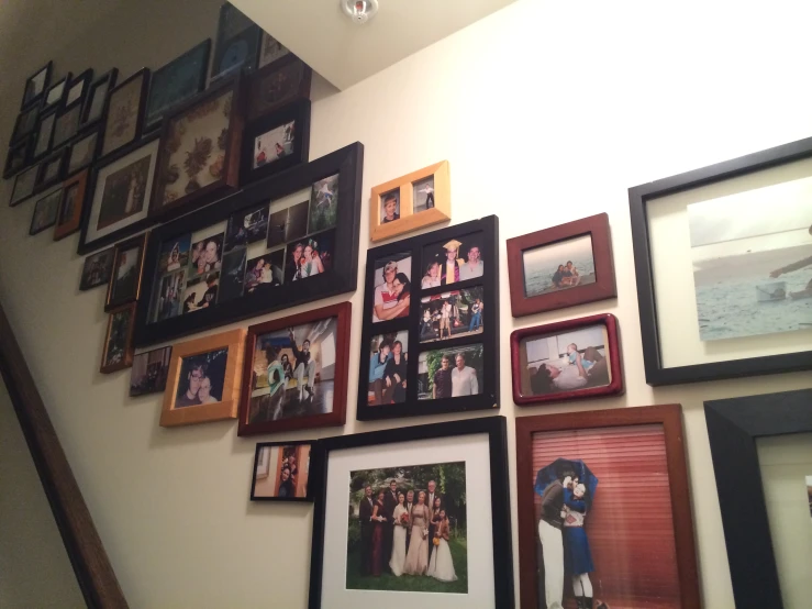 various family pos hanging on a wall, some with them framed