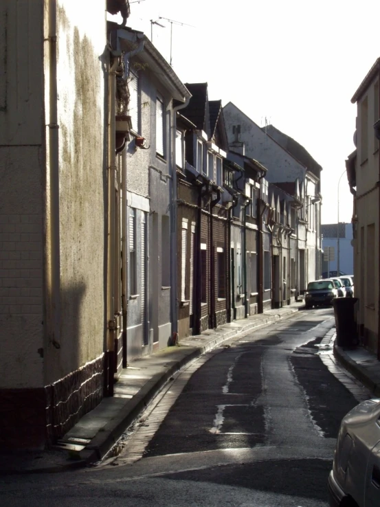 a empty street lined with row houses next to each other